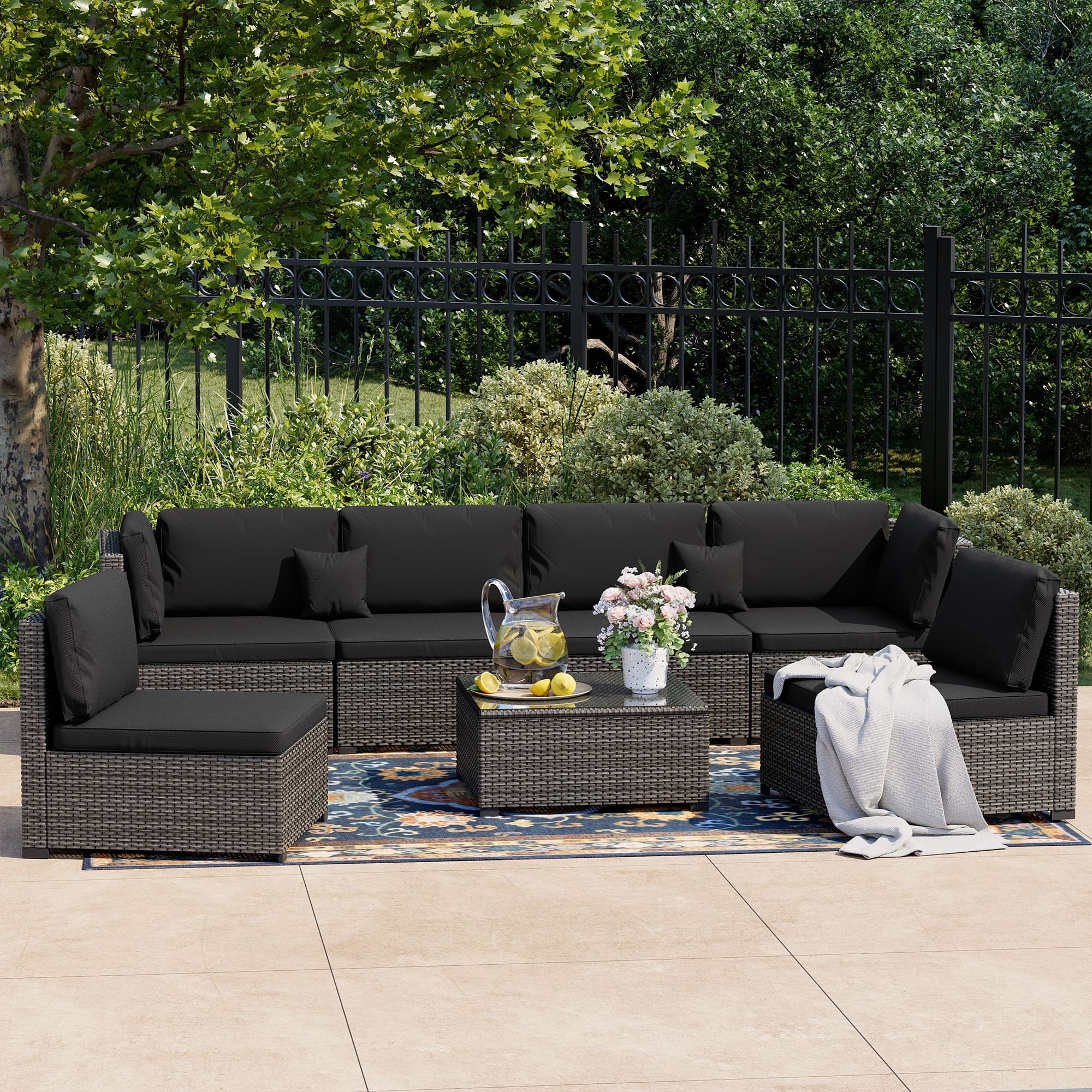 7-Piece Rattan Patio Furniture Set Arranged on Backyard Deck