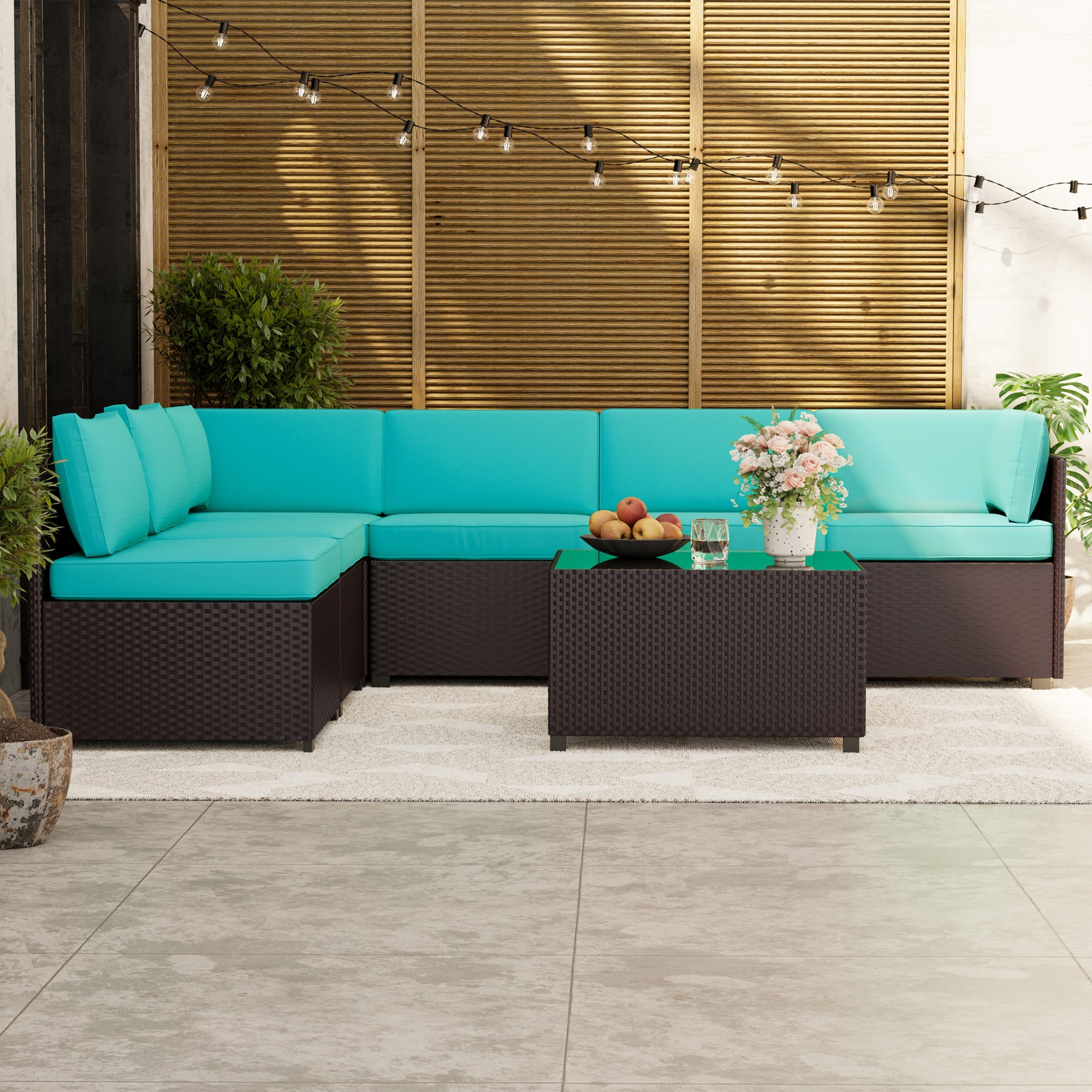7-piece rattan patio sectional sofa set with cushions and glass-top table on outdoor deck