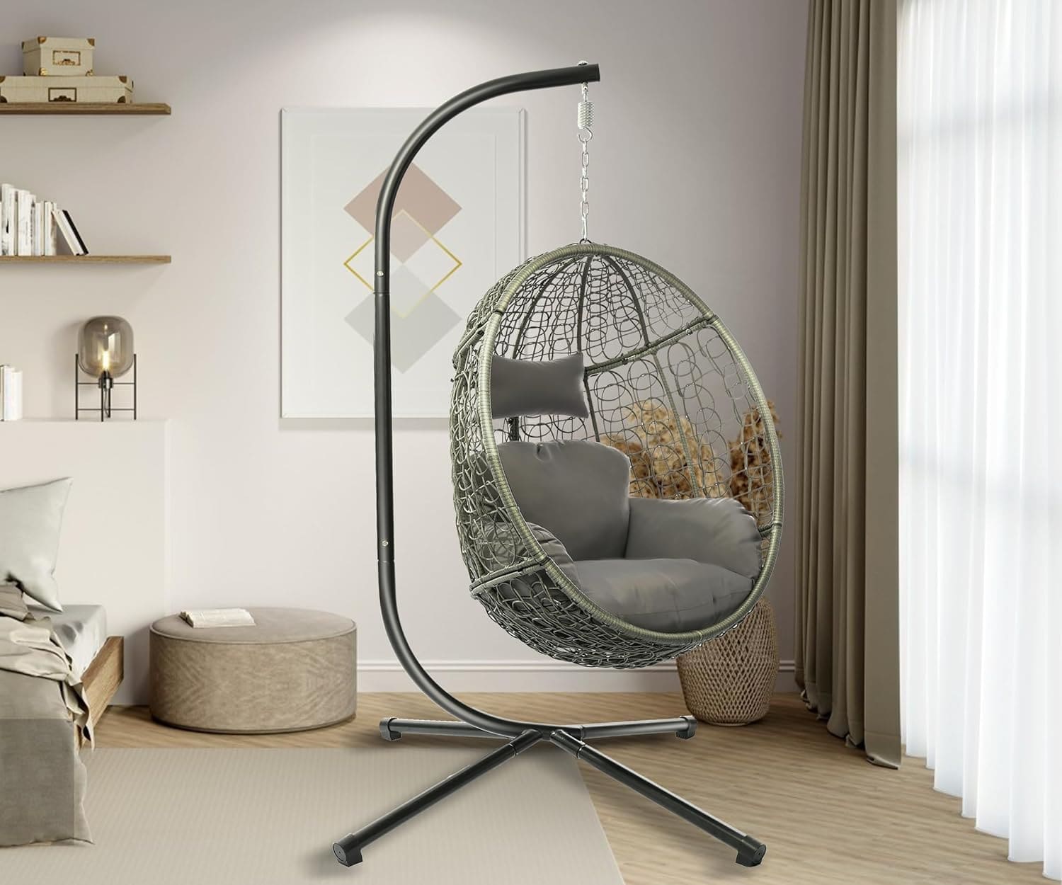 Boho-style hanging egg chair with gray cushion and metal stand, made of rattan for indoor and outdoor use