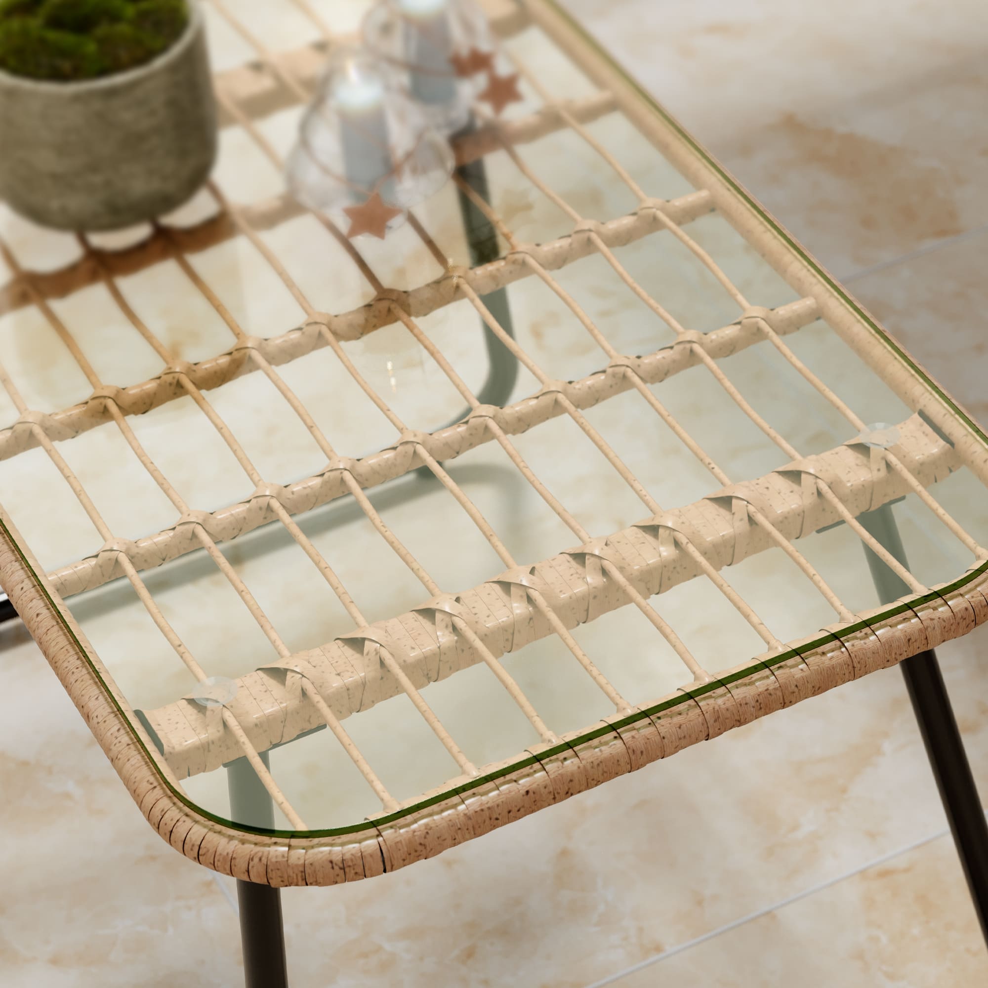 Tempered glass-top outdoor table with wicker frame